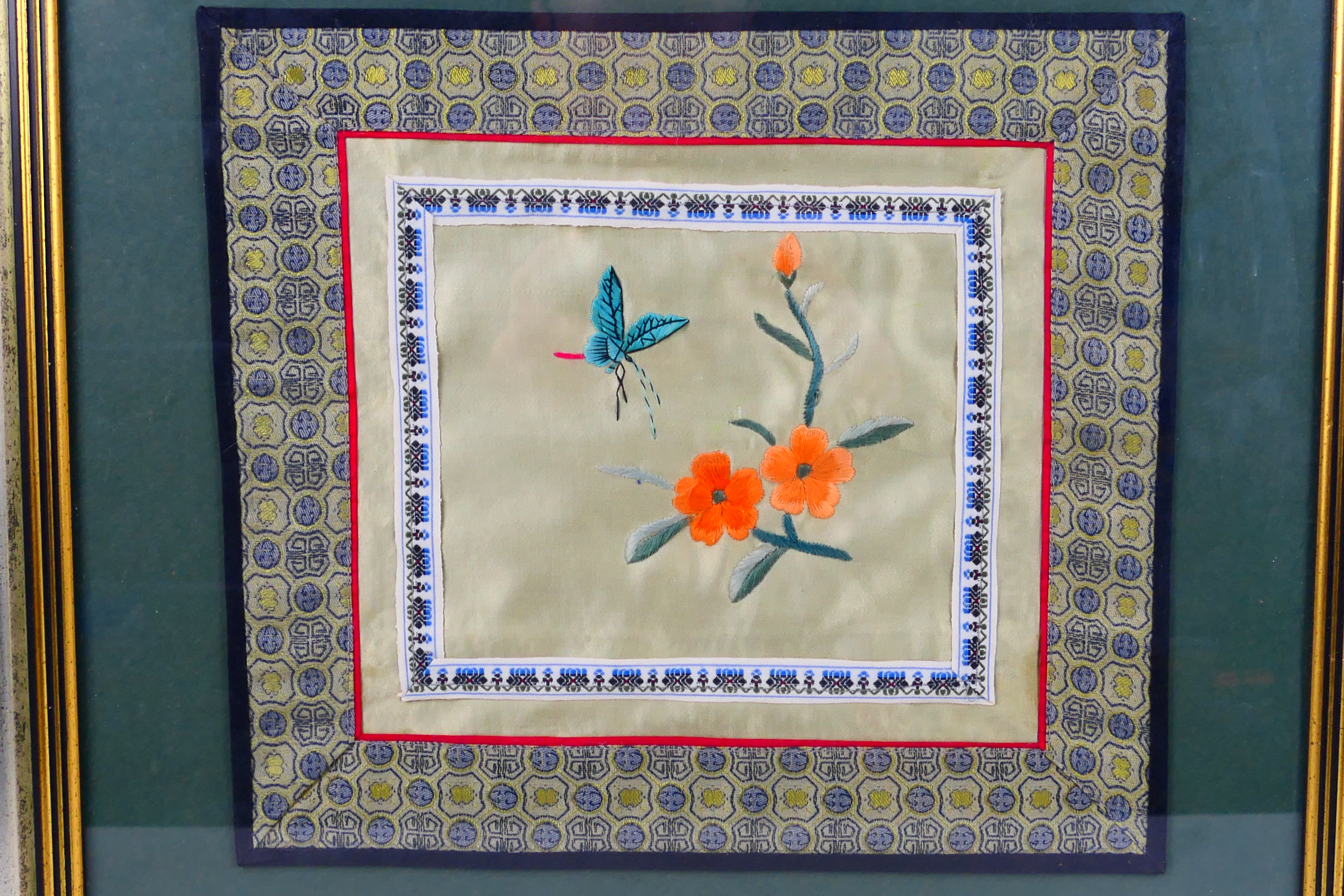 A Chinese embroidery on silk depicting flowers and an insect, framed under glass, - Image 2 of 3