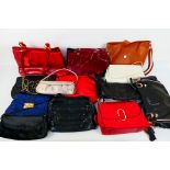 A job lot of predominantly unmarked handbags to include colours of dark blue, dark red, black,