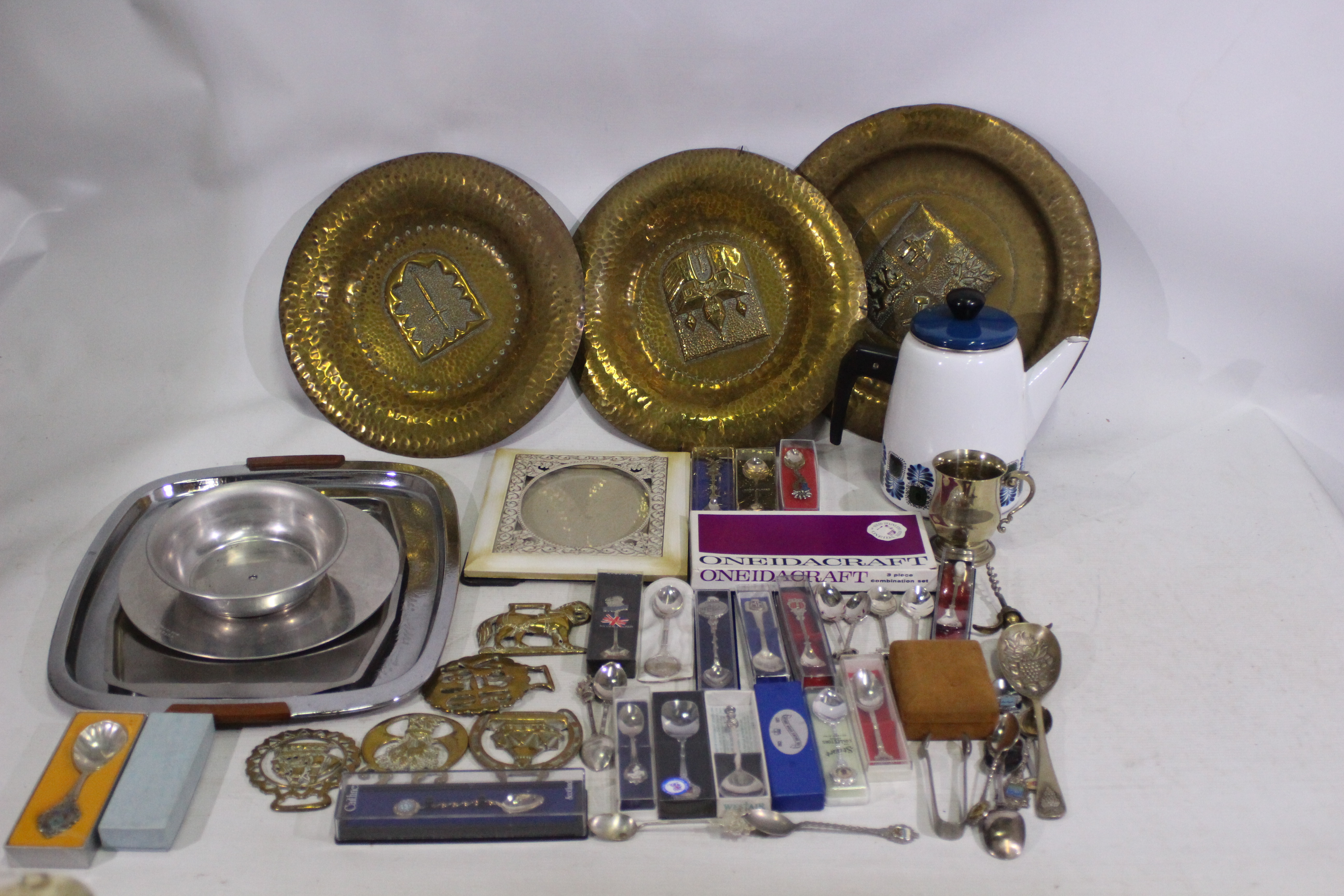 A mixed lot to include mostly boxed metal collector spoons, brass ware, picture frame, and similar.