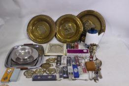 A mixed lot to include mostly boxed metal collector spoons, brass ware, picture frame, and similar.