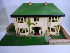 Tri-ang - A vintage wood and metal two storey six room dolls house with a walled garden base and