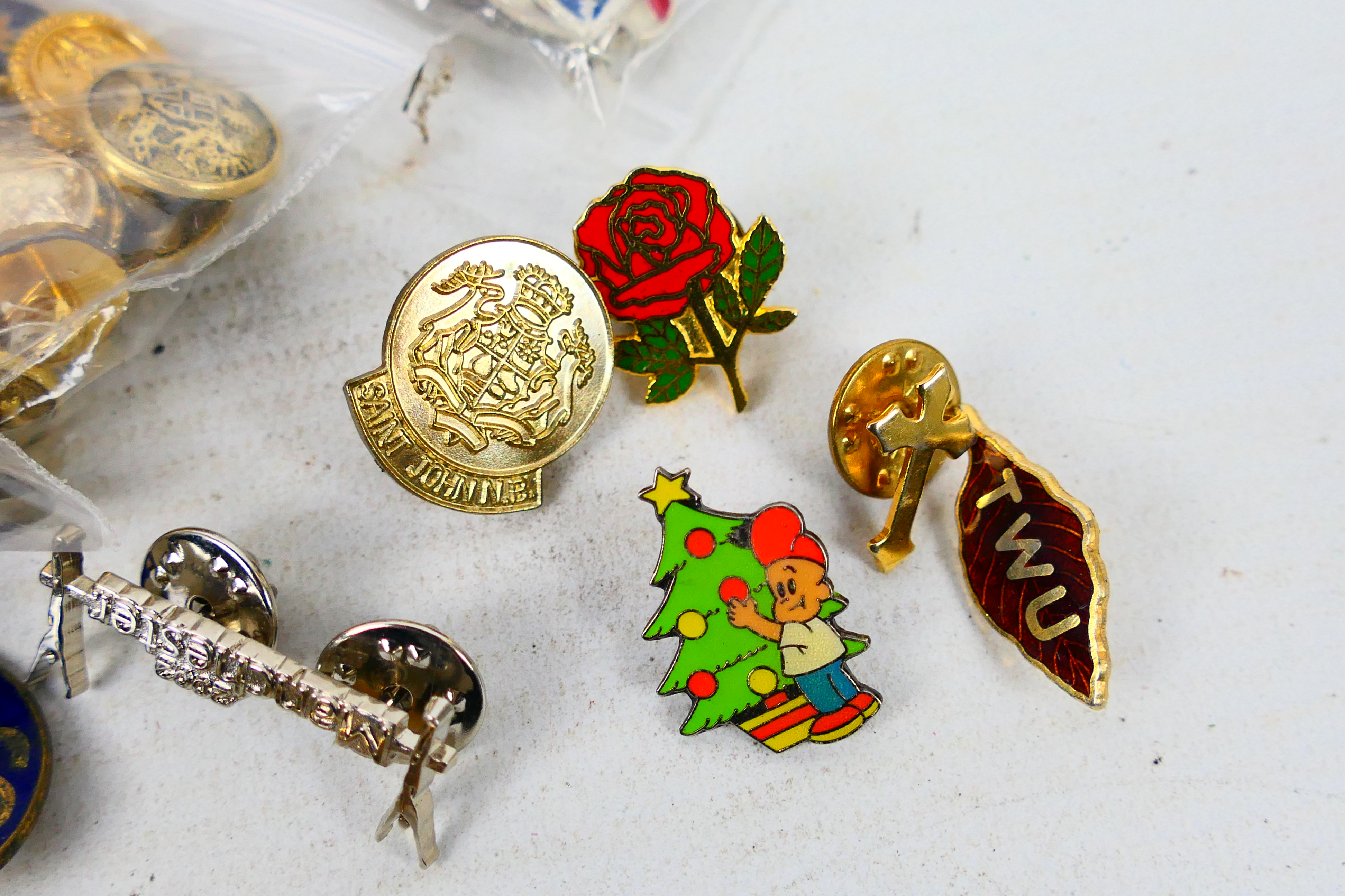 A polished wood box containing a quantity of enamelled pin badges and charms including several with - Image 6 of 7