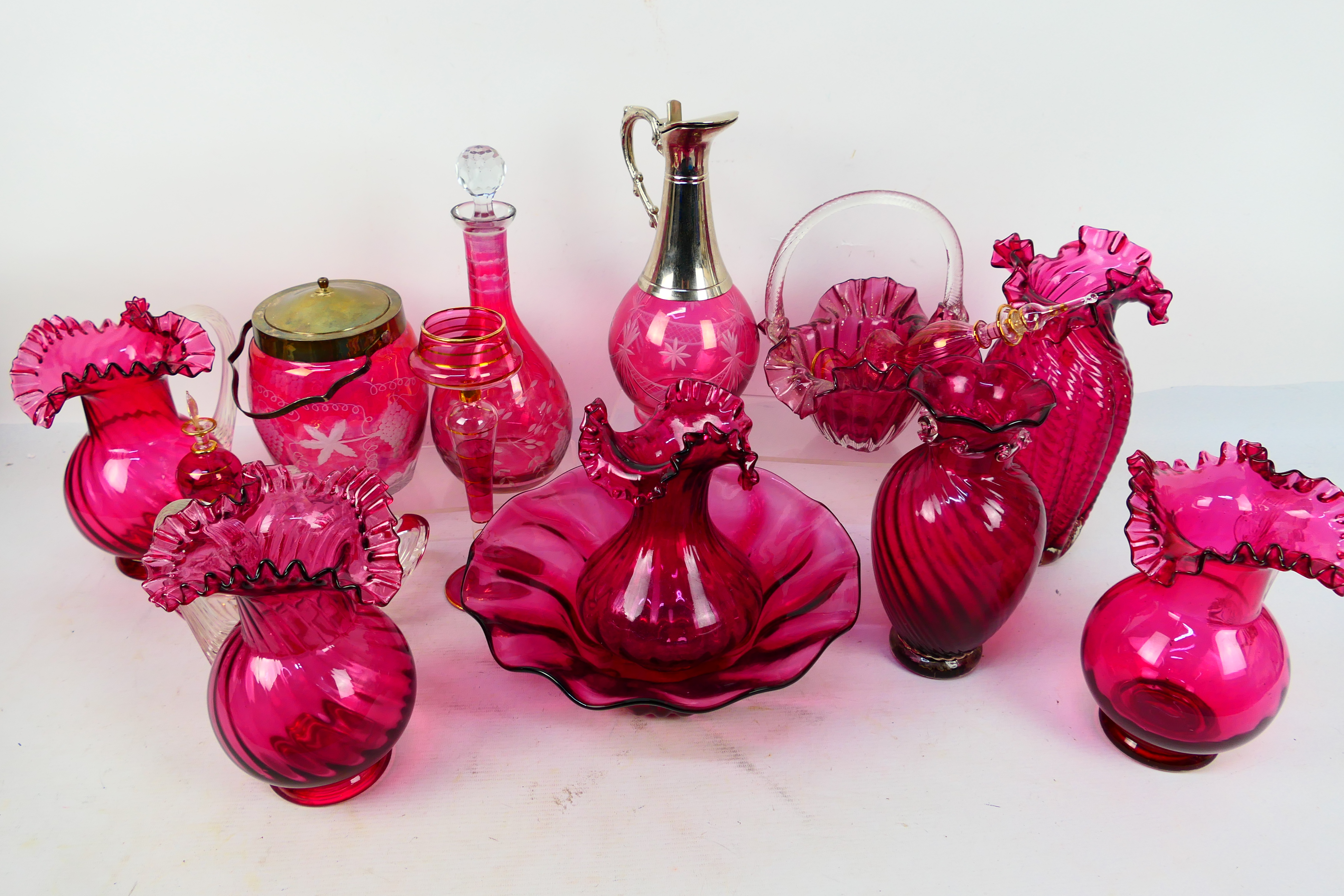 A collection of various cranberry glass pieces to include vases, decanters, bowl and similar,