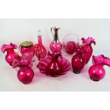 A collection of various cranberry glass pieces to include vases, decanters, bowl and similar,