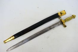A sword in the style of a French artillery gladius sidearm with a ribbed brass hilt,