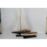 Two decorative model boats mounted to display plinths, largest approximately 87 cm x 61 cm. [2].