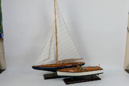 Two decorative model boats mounted to display plinths, largest approximately 87 cm x 61 cm. [2].