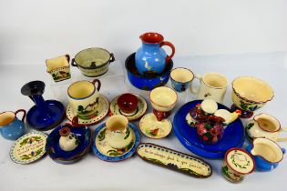 A collection of Torquay pottery wares to include bowls, jugs, cups and other, various manufacturers.