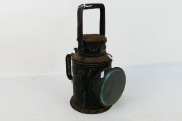 A black painted lantern / lamp marked Mutlow 1940 London, 34 cm (h).