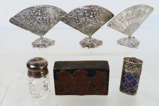 Lot to include three white metal menu holders in the form of fans, a filigree scent bottle holder,