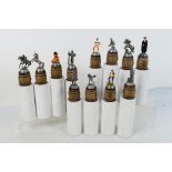Twelve pewter, novelty bottle stoppers by Sterling Classics, contained in original packaging.