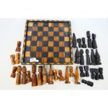 An African carved wood chess set with 10.5 cm (h) king. [2].