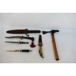 A collection of vintage knives and an axe.