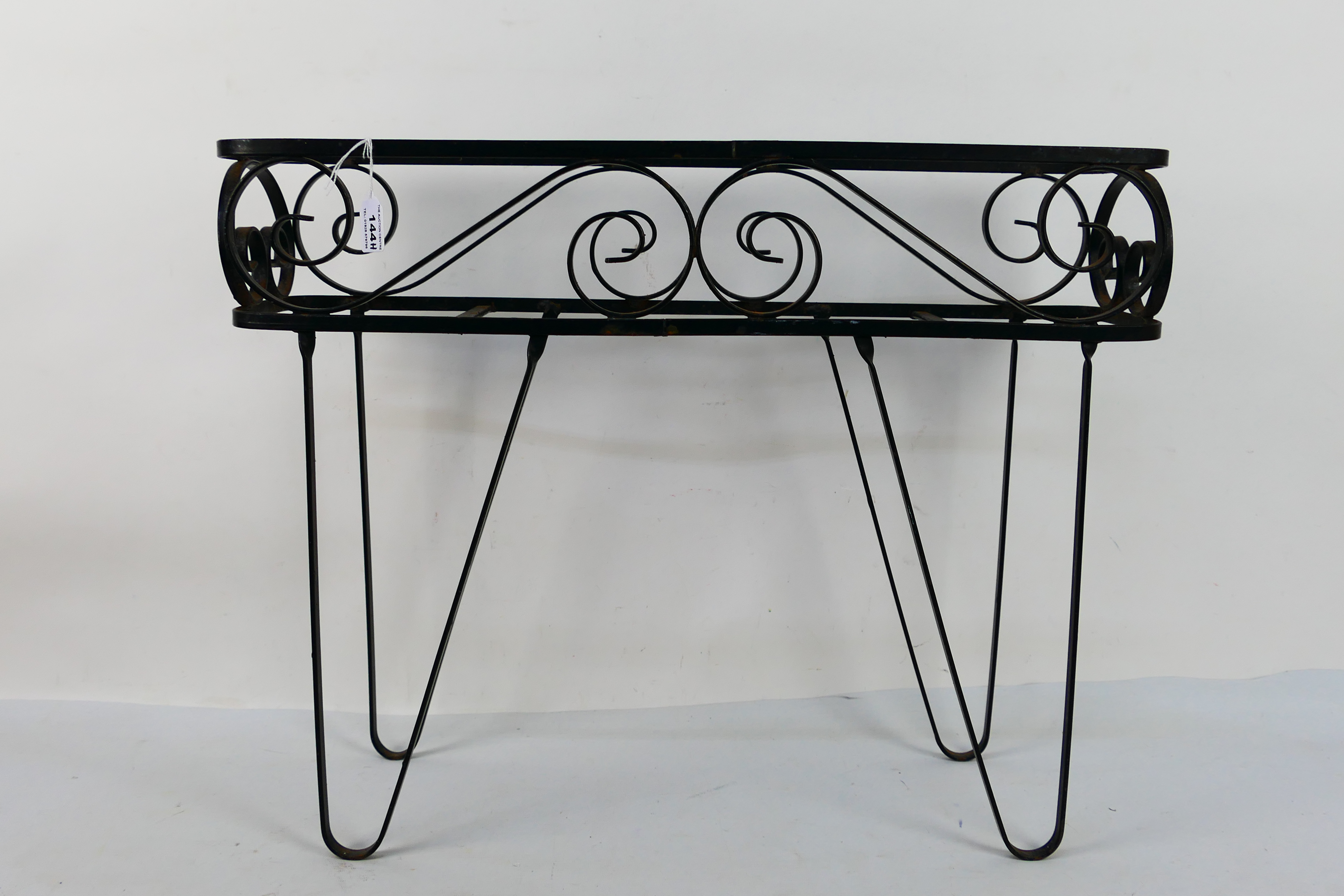 A black painted wrought iron planter stand, approximately 48 cm x 62 cm x 17 cm. - Image 2 of 2