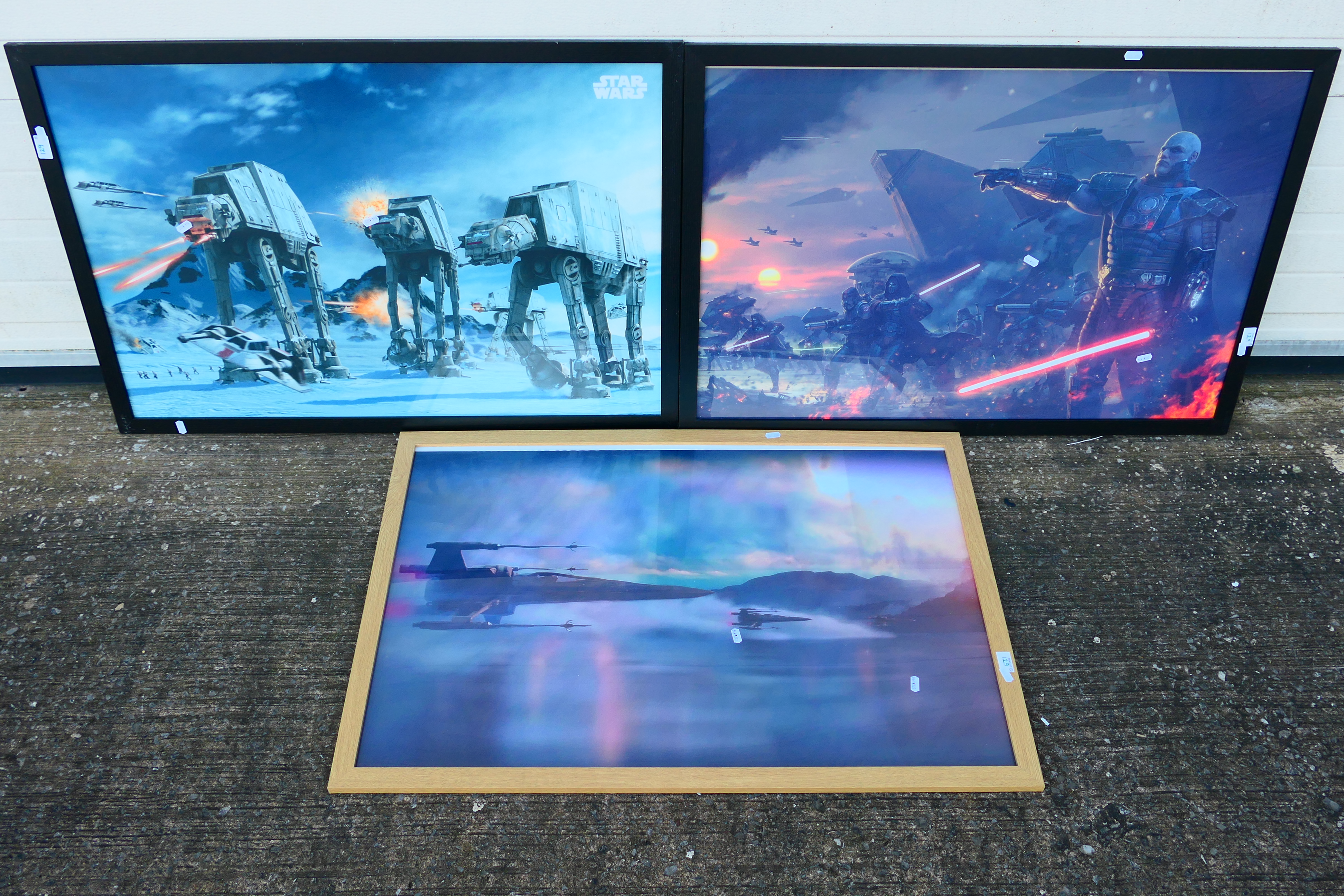Three large Star Wars prints, all framed under glass, approximately 60 cm x 90 cm image size. [3].
