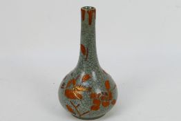 A Chinese celadon crackle glaze bottle vase with red enamel foliate decoration having gilt