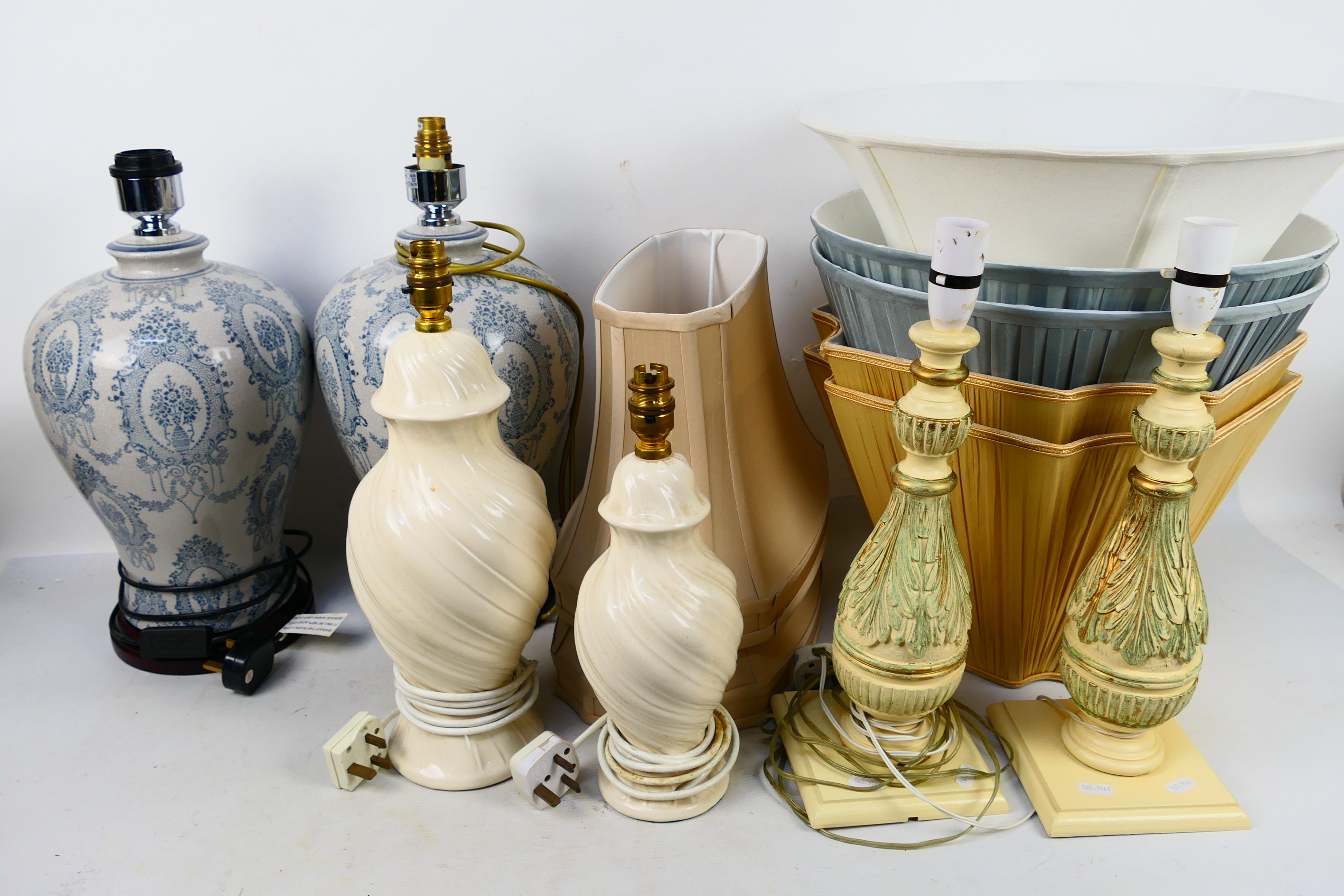 Two pairs of table lamps one pair with blue and white crackle glaze and one further near pair. [2].