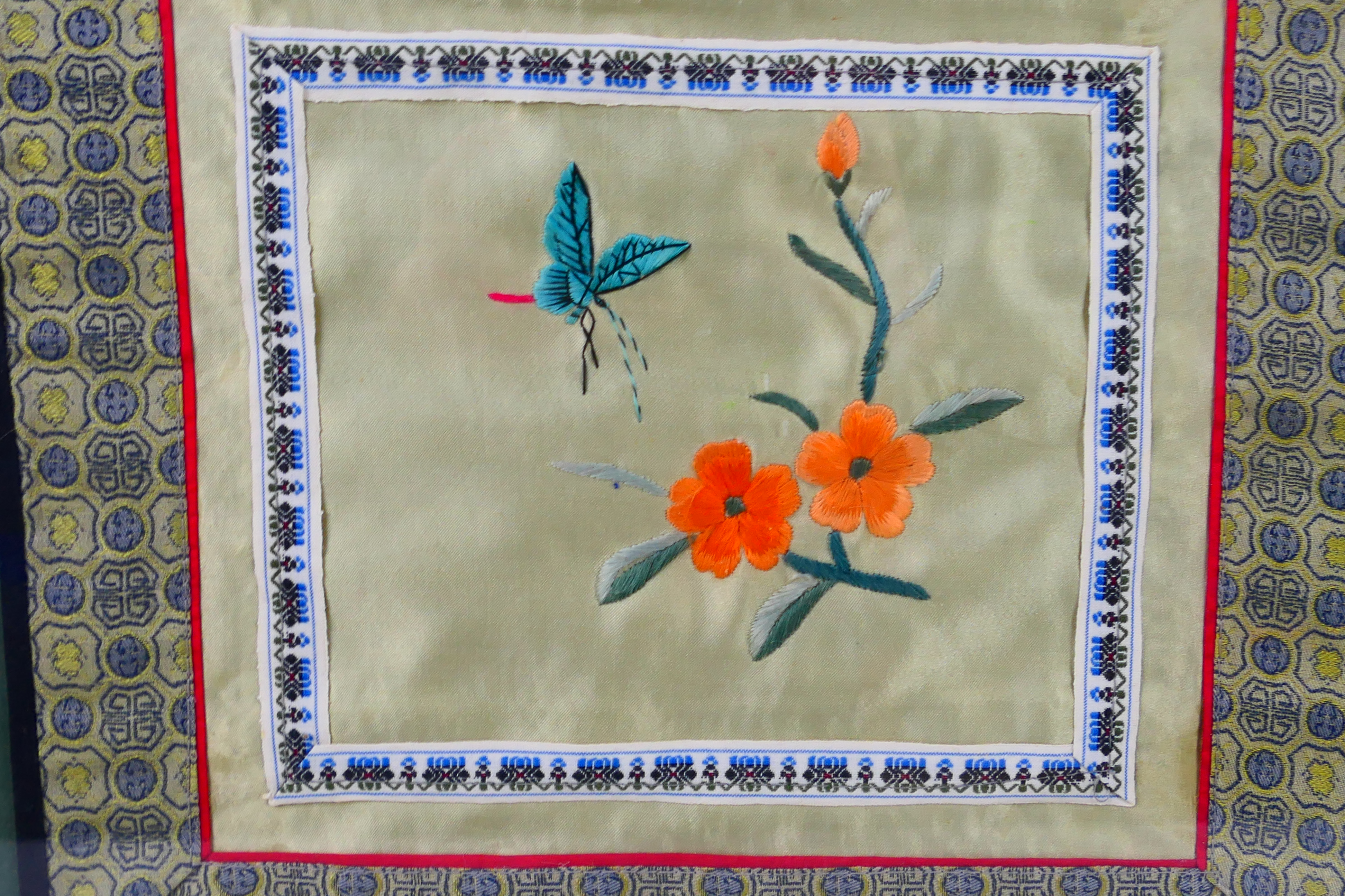 A Chinese embroidery on silk depicting flowers and an insect, framed under glass, - Image 3 of 3