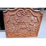 A vintage cast iron fireback depicting t