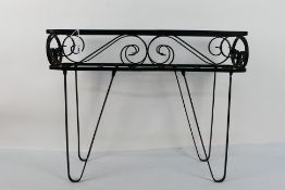 A black painted wrought iron planter sta