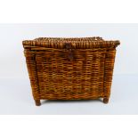 An antique wicker fishing basket / creel
