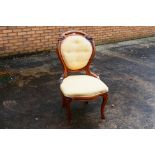 An upholstered bedroom chair with carved