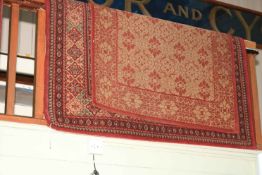 Traditional red ground carpet, 2.30m by 1.60m and Marks and Spencers rug 1.78m by 1.20m. (2).