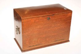 An early 20th Century oak fall front stationery cabinet, 28cm high.