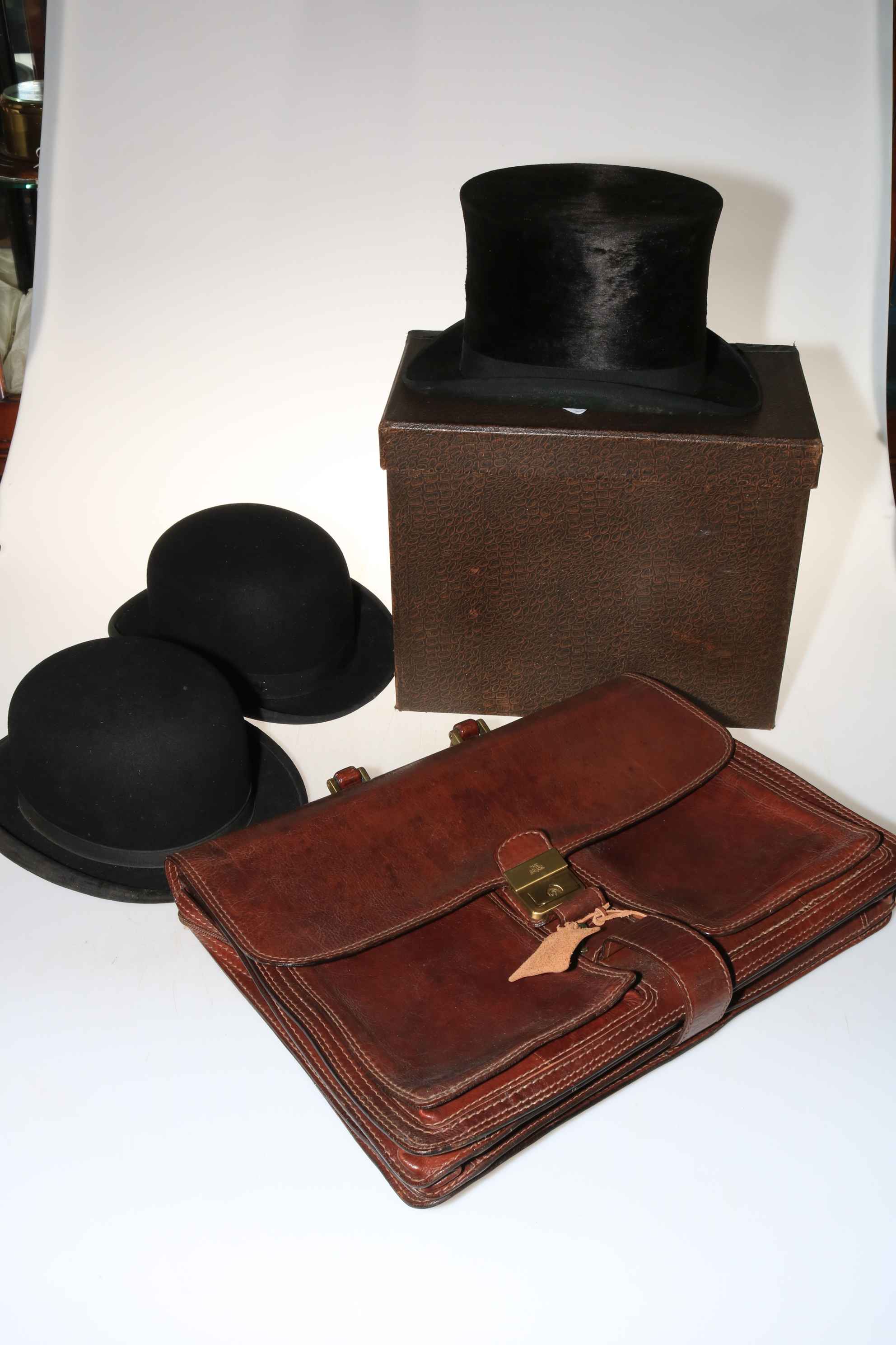 Two hunting bowler hats, top hat in box and 'The Bridge' leather briefcase with key.