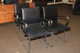 Set of four black leather and chrome cantilever office chairs in the manner of Eames.