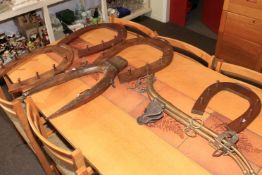 Four horseshoe shaped hunting crop racks, an antique yoke and a pair of brass horse hames.