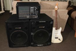 A pair of Carlsbro speakers, electric guitar and a Marlin 10400 Carlsbro amp.