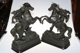 Pair of spelter warriors on horseback.