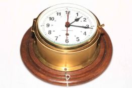 Kelvin Hughes circular brass ships clock on mahogany mount