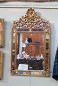 Gilt framed French style cushion mirror, 107cm by 62cm.