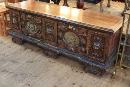 Large continental coffer carved with lion masks and fabric inset panels,