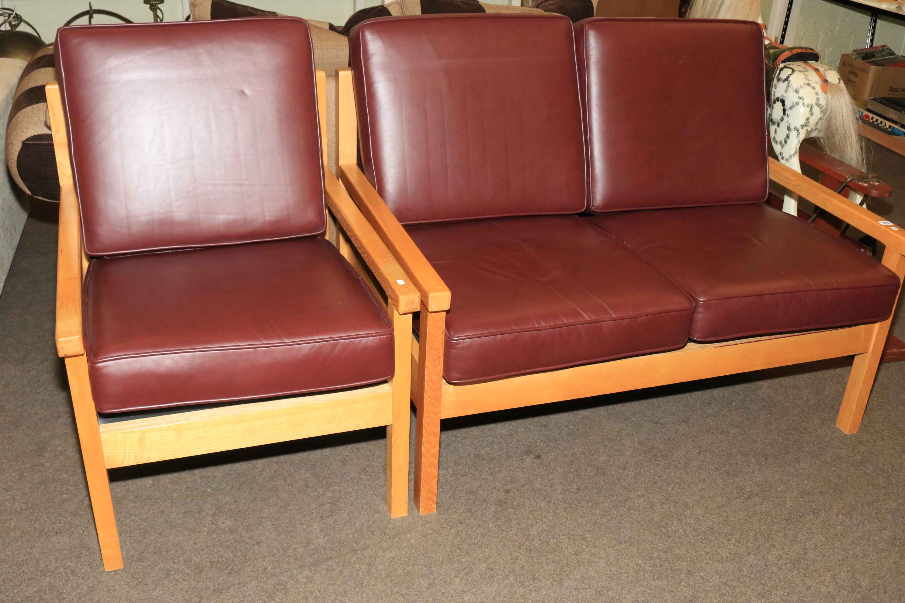 Treske oak framed and burgundy leather two seater settee and chair.