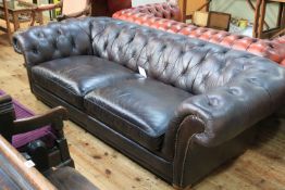 Chocolate brown buttoned leather deep Chesterfield settee.
