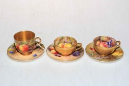 Three Royal Worcester painted fruit cups and saucers by various artists.