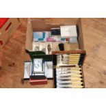 Box of assorted costume jewellery, cutlery, Swiss looping clock etc.