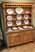 Continental waxed pine dresser, the three tier rack above two drawers with two cupboard doors below,