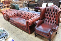 Red buttoned leather three-piece Chesterfield suite comprising three seater settee,