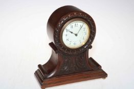 Carved mahogany balloon mantel clock with enamelled dial