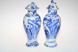 Pair of Chinese blue and white lidded vases decorated with figures in landscape,