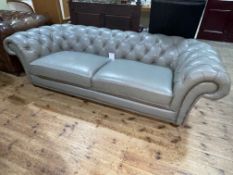 Grey deep buttoned and studded leather three seater Chesterfield settee, 246cm in length.