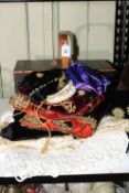 Collection of embroidered fabrics and a sewing box with contents.
