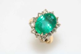 18 carat yellow gold, emerald and diamond cluster ring, the large oval 5.