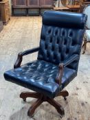 Black deep buttoned leather and studded swivel office desk chair.