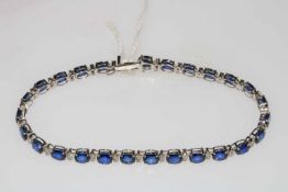 Sapphire and diamond bracelet set in 18 carat white gold, containing 26 oval sapphires,