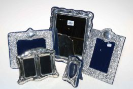 Collection of four photograph frames and large rectangular mirror.